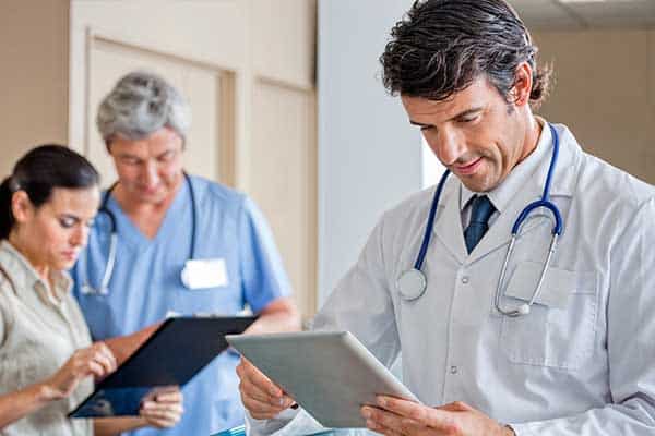 physician reviewing charts in office location